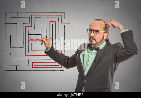 Menschen zeichnen mit Bleistift rot durchgestrichenen Labyrinth zu erreichen lernen Sie Erfolg isoliert graue Wand Office-Hintergrund. Führung Führung Idee Schädel Stockfoto