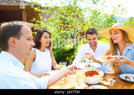 Abendessen Auswahl an italienischen Gerichten und Limonade auf Holztisch im Garten Stockfoto