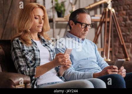 Unwissend paar mit Handys zu Hause Stockfoto