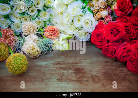 weiße, rote Rosen und Blumen Blumenstrauß Dekor auf Holztisch mit Freiraum Hintergrund Stockfoto