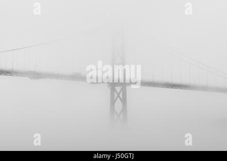 Durch Nebel verschleiert, kreuzt die Angus L. Macdonald Bridge im Hafen von Halifax, Nova Scotia, Kanada. Stockfoto