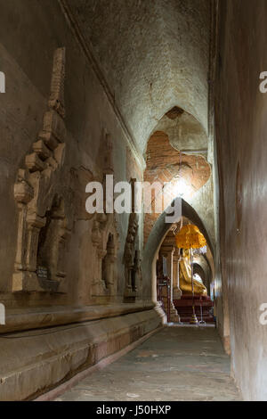 Korridor und große goldene Buddha-Statue im Htilominlo Tempel in Bagan, Myanmar (Burma). Stockfoto