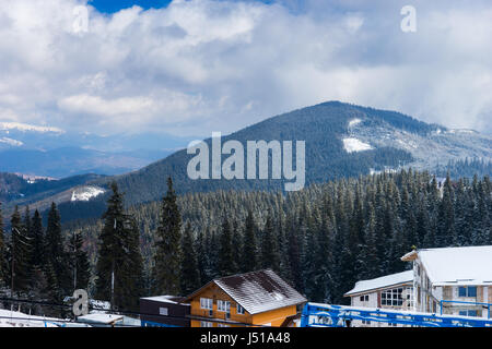 Schnee-Wald in den Bergen in der Nähe von Hütten auf einem schönen frostigen Wintertag Stockfoto