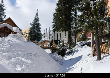 Holzbrücke in einer verschneiten Ski Stadt an einem sonnigen Wintertag Stockfoto