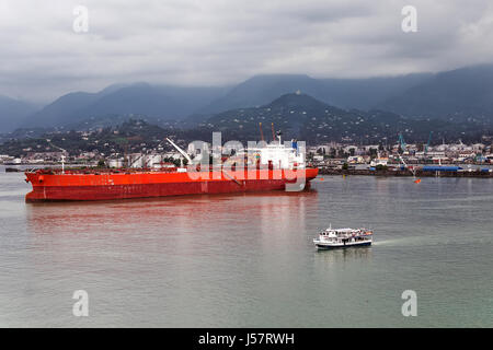 Ozean-Frachtschiff und kleine Touristenboot geschützt vor einem Sturm in der Bucht des Hafens, Batumi, Georgien Stockfoto