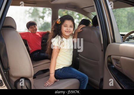 Niedlichen Mädchen und der Junge sitzt auf dem Auto Rücksitz Stockfoto