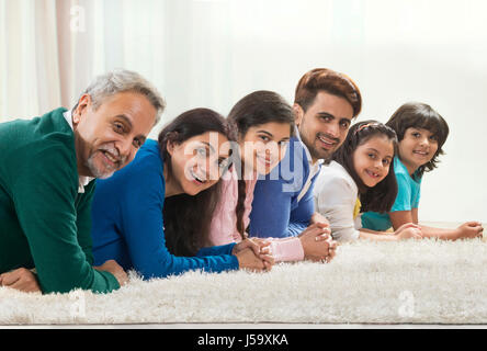 Glücklich drei-Generationen-Familie posiert auf Teppich Stockfoto