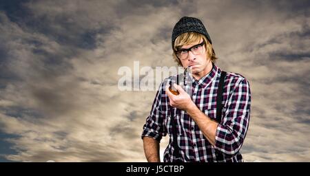 Digitalen Verbund aus zuversichtlich Hipster Pfeife gegen Himmel Stockfoto