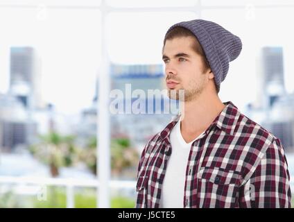 Digital Composite männliche Hipster tragen stricken Hut während wegschauen Stockfoto
