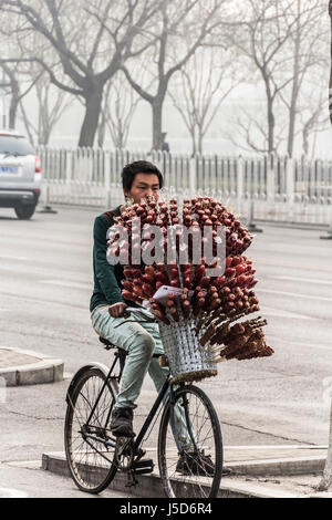 BEIJING, CHINA 26. März 2014:-Straße Verkäufer mit Zucker überzogen Sirup Erdbeeren zu verkaufen Stockfoto