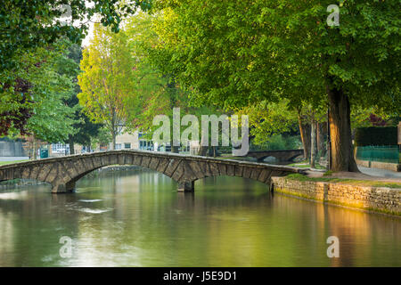 Frühling-Sonnenaufgang am Fluss Windrush im Dorf Bourton-on-the-Water, Cotswolds, Gloucestershire, England. Stockfoto