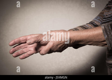 Hand of Senior Woman massieren Handgelenk, Frankreich Stockfoto