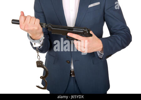 Nahaufnahme Foto einer Handcuffed Hand mit einer Pistole Stockfoto