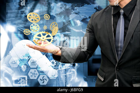 Industrielle Internet der Dinge 4.0 Konzept. Business Mann Anzug Hand Holding golden 3D Rendering Zahnräder und Grafik mit abstrakten Automatisierung Maschine indus Stockfoto