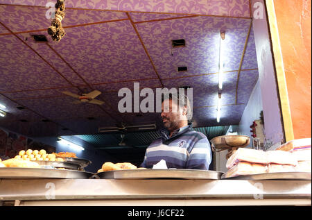 Eine indische Ladenbesitzer verkaufen gebraten Speiselokal in einer Straße in Pushkar, Rajasthan, Indien am 17. Februar 2016. Stockfoto