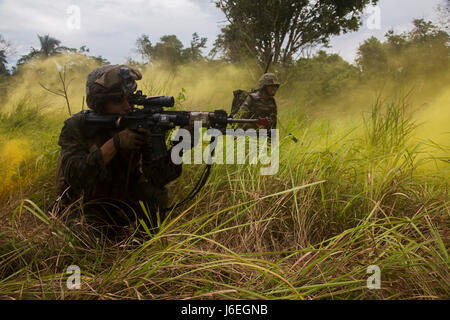 U.S. Marine Corps Lance Cpl. Jacob Gonzalez, ein Schütze mit Golf Company, 2. Bataillon, 4. Marineregiment und malaysischen Soldaten führen Kumpel stürzt während einen gemeinsamen simulierten amphibischen Angriff während der Landung Kraft Zusammenarbeit flott Bereitschaft und Training (LF Karat) 2015 am Tanduo Strand, Osten Sabah, Malaysia, 19. August 2015. LF-Karat soll zu stärken, die Interoperabilität bei der amphibischen Planung zu erhöhen und Operationen und die Kernkompetenz setzt zwischen den Vereinigten Staaten und die Nationen von Indonesien, Malaysia und Thailand. (U.S. Marine Corps Foto von MCIPAC Bekämpfung der Kamera Lanc Stockfoto