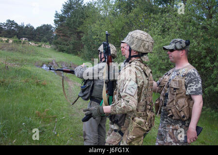 Trainer des Yavoriv Combat Training Center beaufsichtigen ukrainische Soldaten des 1. Airmobile Bataillons, der 79. Air Assault Brigade, während der Waffenräumung und der Paarung des Bewegungstrainings, unterstützt von Mentoren des 45. Infanterie-Brigade-Kampfteams der US-Armee während einer multinationalen Rotation. Stockfoto