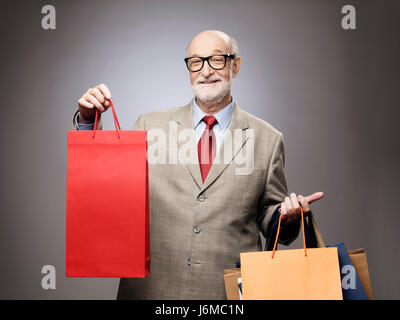 Glücklich lächelnd senior woman mit Einkaufstüten Stockfoto