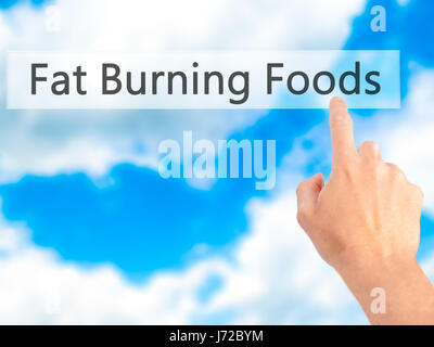 Fat Burning Foods - Hand drücken einer Taste auf unscharfen Hintergrund Konzept. Wirtschaft, Technologie, Internet-Konzept. Stock Foto Stockfoto