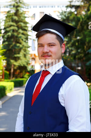 Happy graduateing Student trägt die Staffelung hat Stockfoto