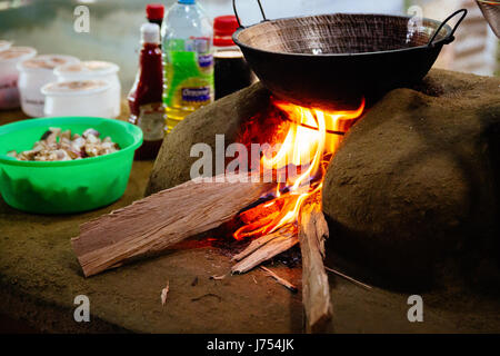 Gemüse gebraten über ein Holz gefeuert Herd aus Schlamm und Lehm in einem traditionellen srilankischen Außenküche gemacht. Stockfoto