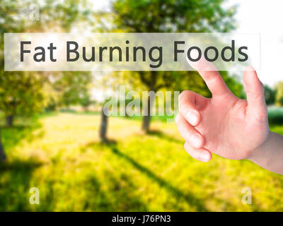 Fat Burning Foods - Hand drücken einer Taste auf unscharfen Hintergrund Konzept. Wirtschaft, Technologie, Internet-Konzept. Stock Foto Stockfoto