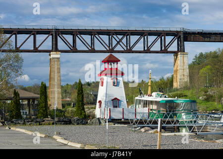 Parry Sound Hafen Leuchtturm mit Eisenbahnbrücke im Hintergrund, Ontario, Kanada Stockfoto