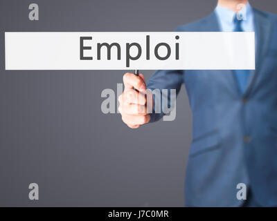 Emploi (Beschäftigung in Französisch) - Geschäftsmann Hand mit Schild. Wirtschaft, Technologie, Internet-Konzept. Stock Foto Stockfoto