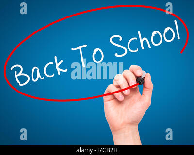 Hand des Mannes Back To School mit schwarzem Filzstift auf Bildschirm zu schreiben. Isoliert auf blau. Wirtschaft, Technologie, Internet-Konzept. Stock Bild Stockfoto