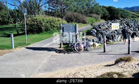 Melden Sie an Board sagen Wand Nordstrand, zwei Fahrräder, zwei Personen in Coffs Harbour, New South Wales, Australien. Stockfoto