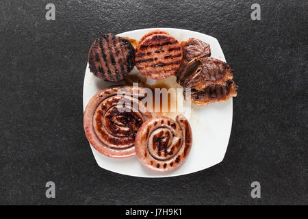 Sortierte leckeres Gegrilltes Fleisch mit Gemüse über die Kohlen auf einem Grill Stockfoto