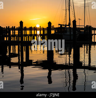 Sonnenuntergang über Dock und Segelboot in Florida Stockfoto