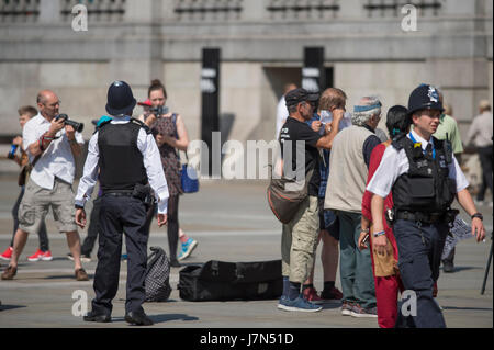 London, UK. 25. Mai 2017. Pendler und Touristen genießen heißen Sonnenschein und hohen Temperaturen heute Morgen. Polizei vermischen sich mit Touristen auf dem Trafalgar Square. Bildnachweis: Malcolm Park Leitartikel/Alamy Live-Nachrichten. Stockfoto