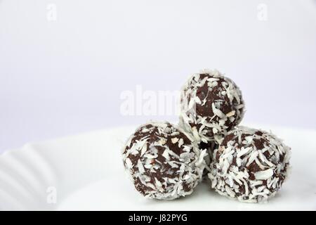 Weihnachtsgebäck auf einem Teller - Rumkugeln in Kokosnuss. Traditionelle hausgemachte handgemachte Tschechische Süßigkeiten. Stockfoto