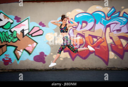 Frau laufen und springen, Fit, zu halten, trägt bunte Sportbekleidung Stockfoto
