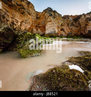 Grünen Steinen am Strand von Porto de Mos in Lagos, Algarve, Portugal Stockfoto