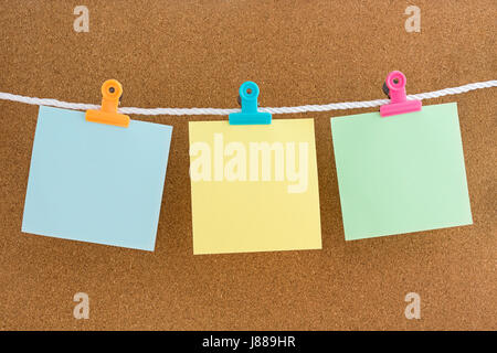 Leere Notizen mit Buchstabenclips auf Kork-Pinnwand Stockfoto