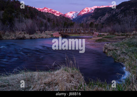 Frühling-Sonnenaufgang auf den Gipfeln im Rocky Mountain National Park mit Big Thompson River fließt im Vordergrund Stockfoto