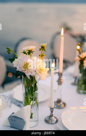 Weiße Astern auf dem Tisch im Restaurant. Hochzeitsdekorationen. Hochzeit in Montenegro. Stockfoto