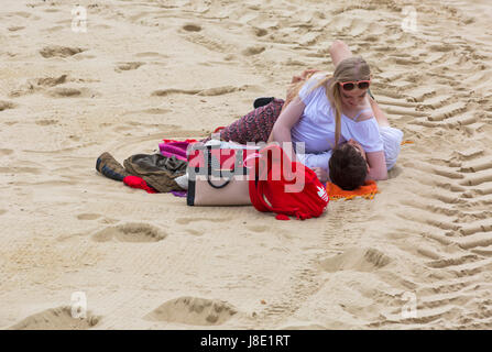 Bournemouth, Dorset, Großbritannien. 28 Mai, 2017. UK Wetter: bedeckt Tag in Bournemouth Strände, die Besucher des Seaside Kopf Die meisten von der Bank Holiday Wochenende zu machen. Junges Paar am Strand liegend auf Decke auf dem Sand umarmen und umarmt einander an. Credit: Carolyn Jenkins/Alamy leben Nachrichten Stockfoto
