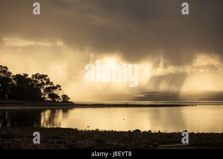 Sonnenstrahlen kommen aus den Wolken mit einer Reflexion im Wasser auf Kangaroo Island South Australia Stockfoto