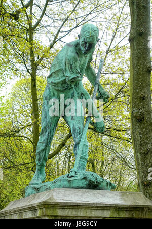 Le Faucheur (der Sensenmann) von Constantin Meunier ist eine Skulptur im Cinquantenaire Park in Brüssel, Belgien. Es zeigt eine mächtige Figur eines Bauern, der Getreide erntet, symbolisiert Arbeit und die Verbindung zur Natur und repräsentiert Meuniers Fokus auf die Arbeiterklasse. Stockfoto