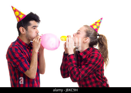 Junges Paar bläst Luftballons Stockfoto