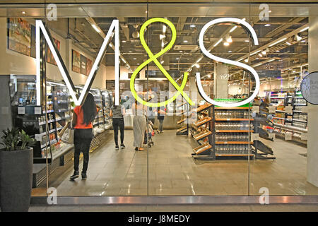 M&S M & S-Schild auf Glasfenstermarken montiert und Spencer M & S-Geschäft im Westfield Shopping Centre, Käufer, die ihr Lebensmittelgeschäft East London UK machen Stockfoto