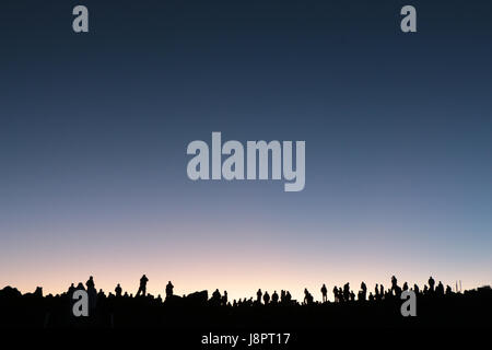 Touristen und einheimische Silhouette gegen Morgendämmerung Licht Zeuge Sonnenaufgang vom Gipfel des Haleakala Vulkan, Maui, Hawaii. Stockfoto