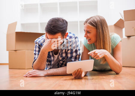 Junges Paar bewegt sich in ihrer neuen Heimat. Es ist Zeit zum Auspacken. Stockfoto