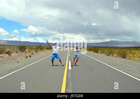 Paar in Liebe und glücklich Tänze in der Mitte der Route auf der geraden von Tin Tin, Salta, Argentinien Stockfoto