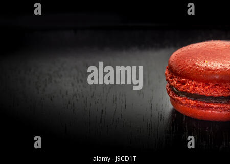 Süße französische Makronen oder Macaron auf schwarzer Holztisch. Platz für Text. Stockfoto