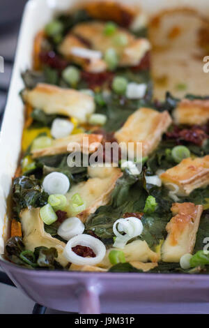 Gemüsetorte in eine Auflaufform legen Stockfoto