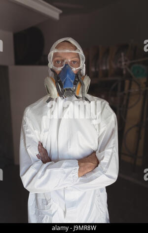 Porträt eines Mitarbeiters mit Gasmaske im stehen auf dem Fahrrad workshop Stockfoto